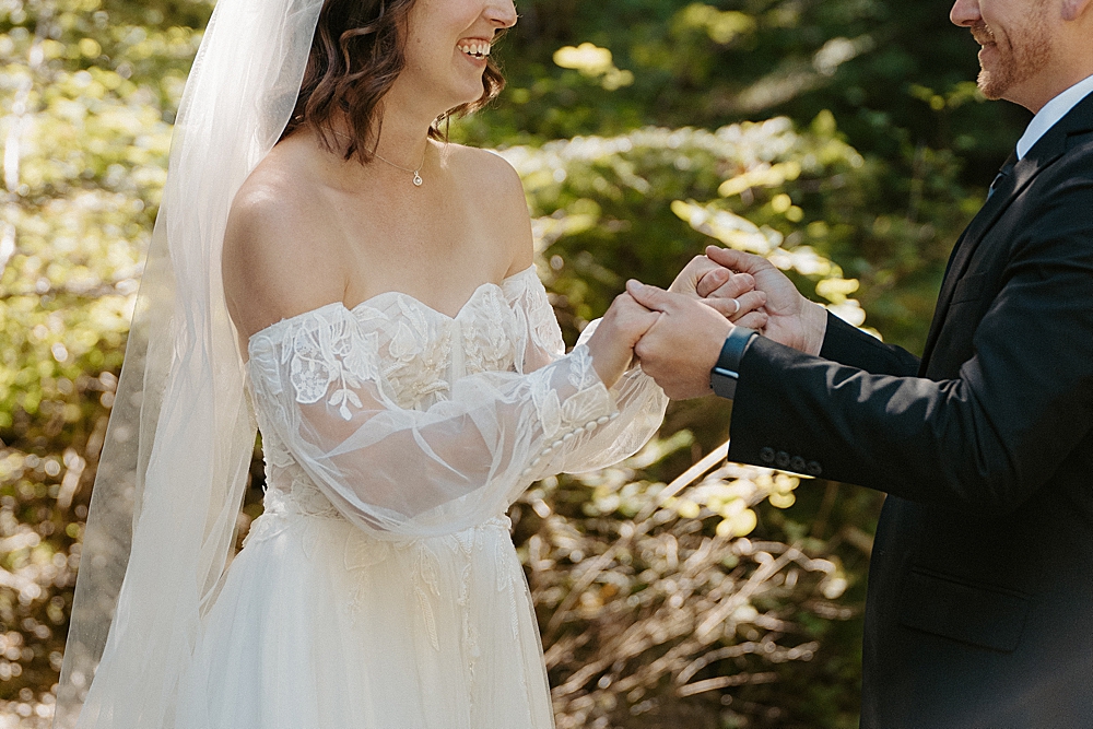 Up close of bride and groom holding hands