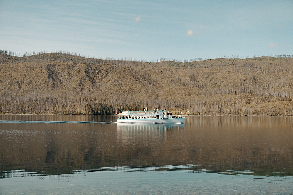 Lake McDonald tour boat with all the guests looking to the shore
