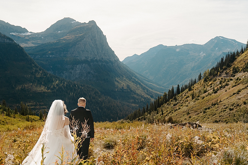 Bride and groom walking down a trail through the fall foliage at Big Bend for their autumn elopement
