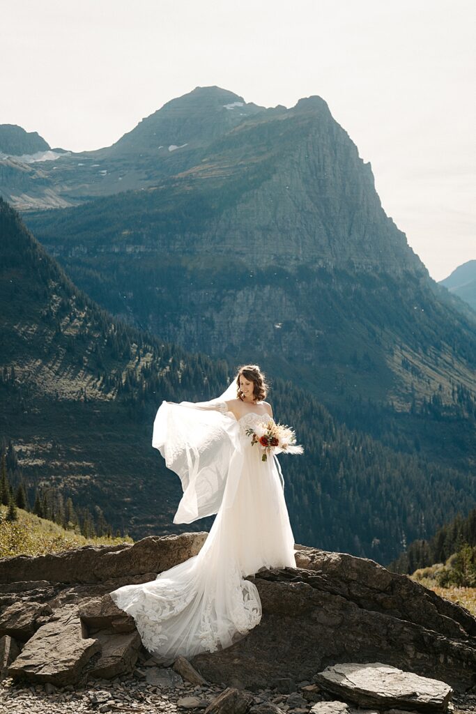 Bride holding her veil out at Big Bend in Glacier