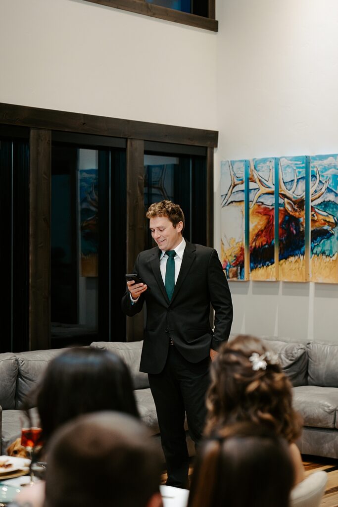 Groomsmen in a black suit giving a toast