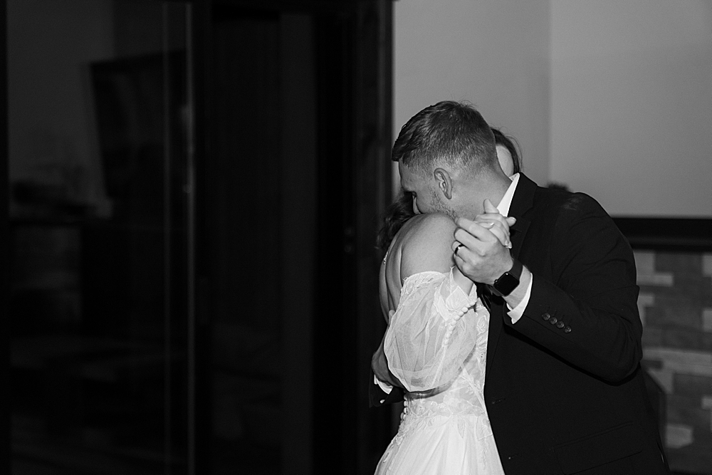 Black and white of a bride and groom sharing their first dance