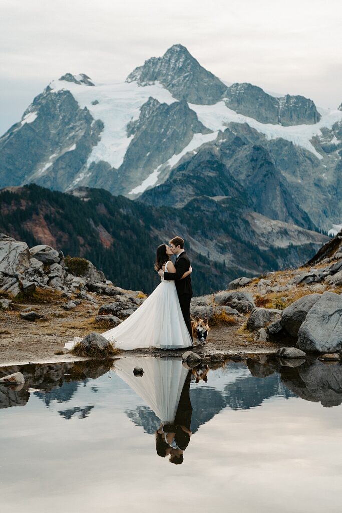 Bride & groom kissing at the end of their sunrise Mount Shuksan elopement ceremony. 