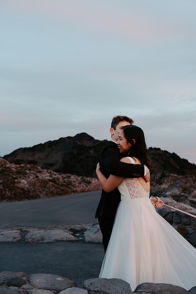 Bride and groom hugging at Artist Point at sunrise for their elopement.