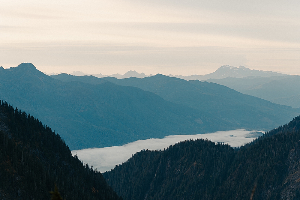 Landscape image of a cloud inversion low in a valley among some Washington mountains.