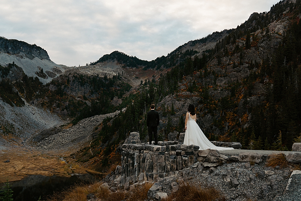 Bride walking out to her groom on a stone platform for their Washington elopement.