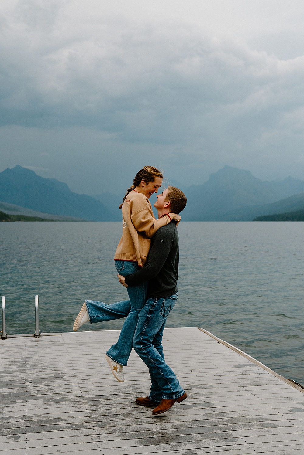 Man lifting his fiancée on the Apgar dock at Lake McDonald